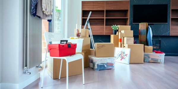 Large living room with stack of moving boxes moving in or out cleaning